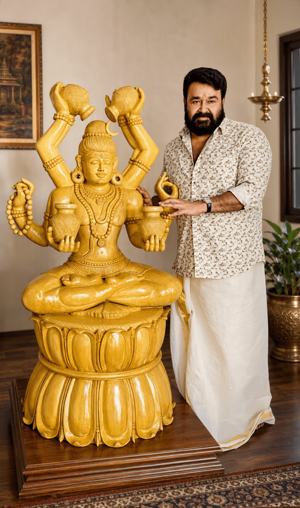 Sri Mohanlal standing beside the golden Lord Shiva idol with sacred kalashas